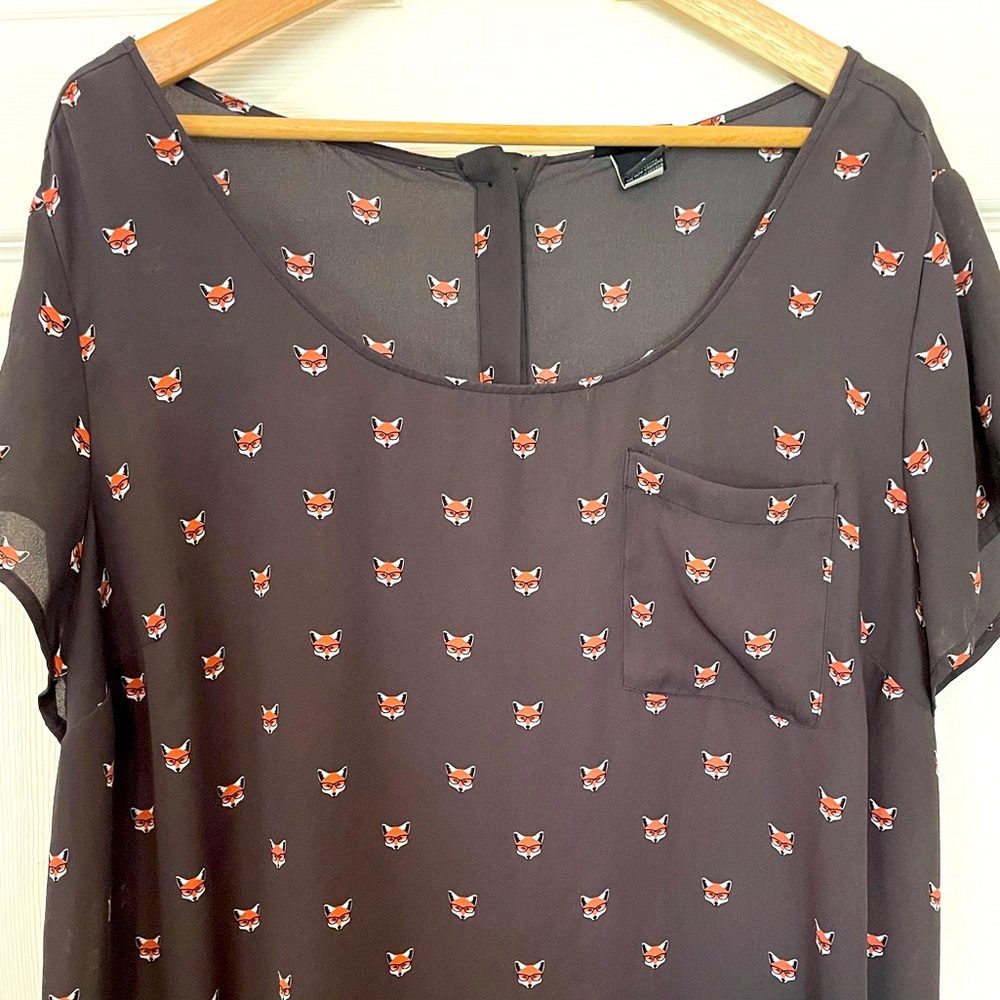 Women’s shortsleeved, “Torrid,” “foxy” black blouse